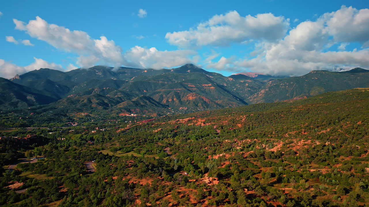 Beauty of Capitol Reef National Park, Utah, United States. Rocky landscape of bentonite clay covered with greenery. Verdant mountains at backdrop