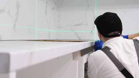 master of installed kitchen furniture during work installation of accessories in the kitchen master of installed kitchen furniture during work installation of accessories in the kitchen