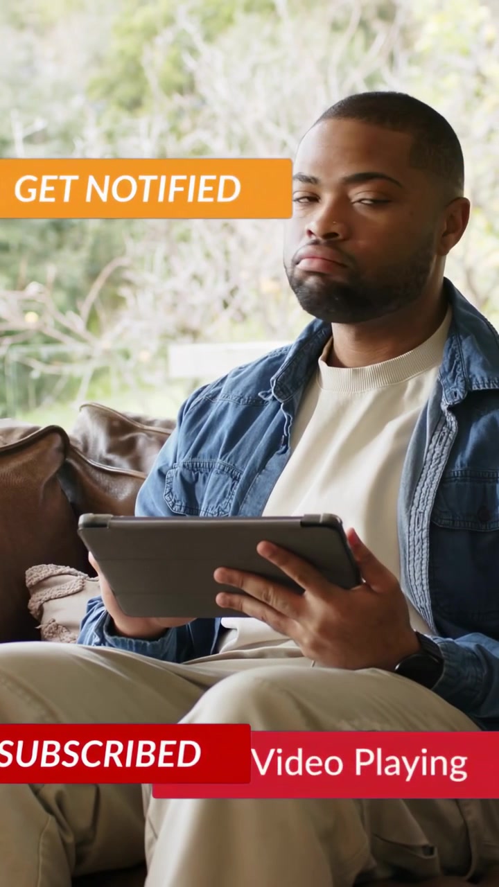 Vertical video: Man scrolling tablet on sofa, social badges popping over tablet while checking feed