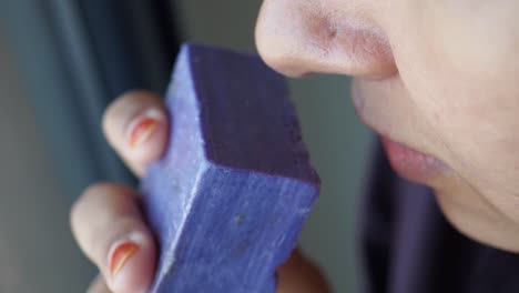 woman smelling purple soap