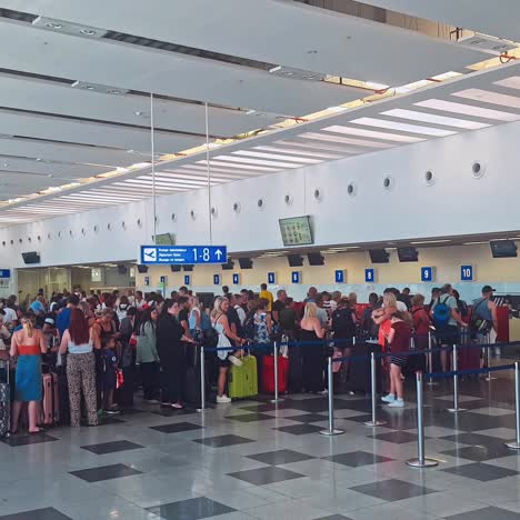 queue of people waiting at boarding gate at airport