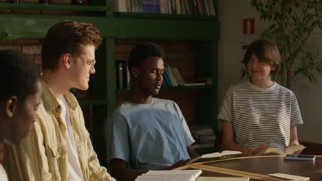 group of diverse students studying in a library