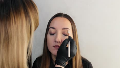 makeup artist applies makeup to the client