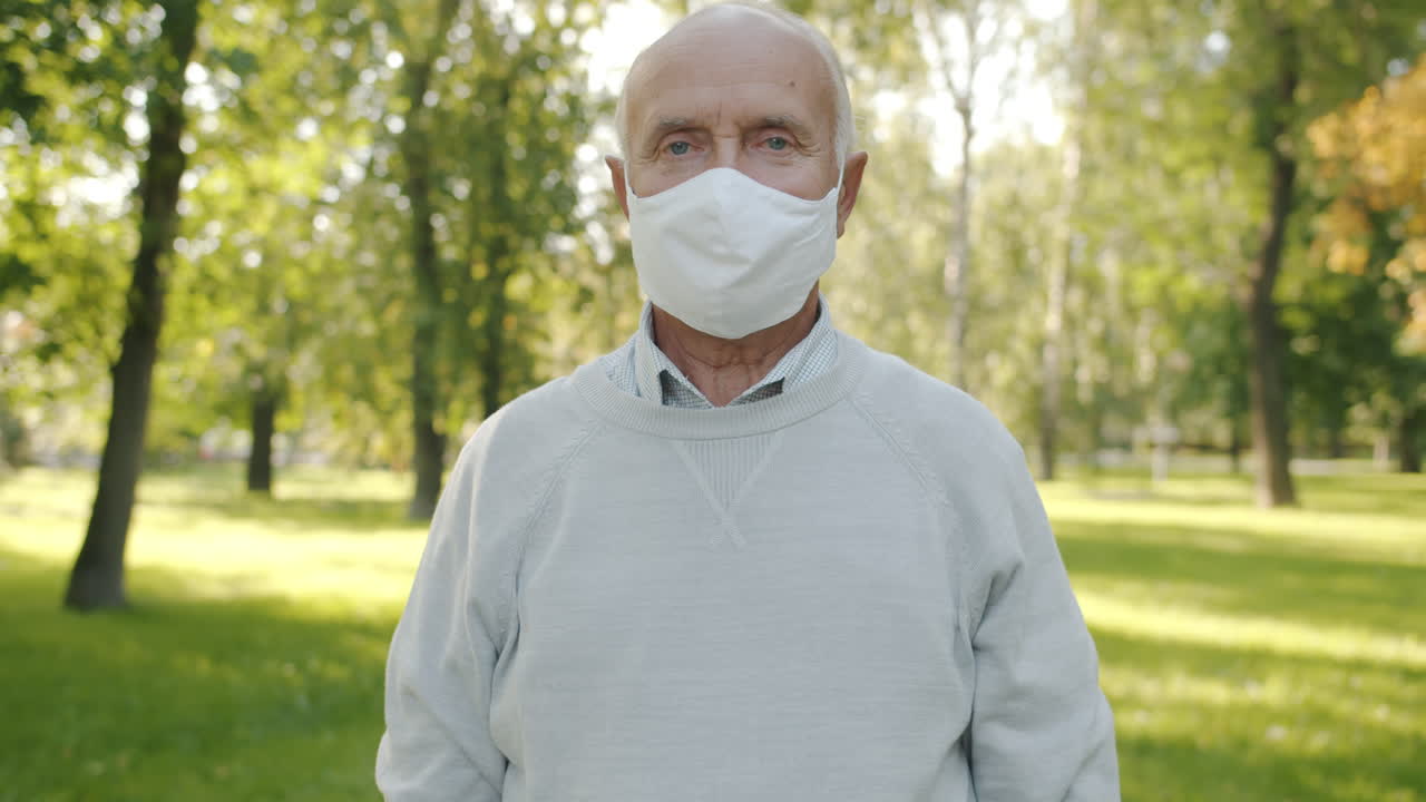 Elderly Man Wearing a Face Mask in a Park