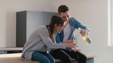 couple celebrating house ownership with a champagne.