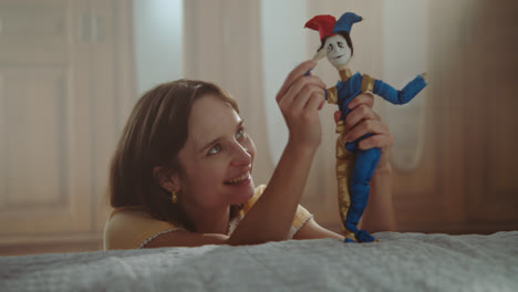 a girl playing with dolls in her room