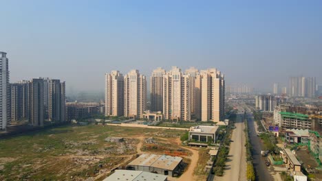 aerial drone shot capturing massive high rise buildings in noida india