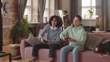 teenage boy and girl enjoying console game