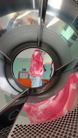 girl looking through laundry tunnel