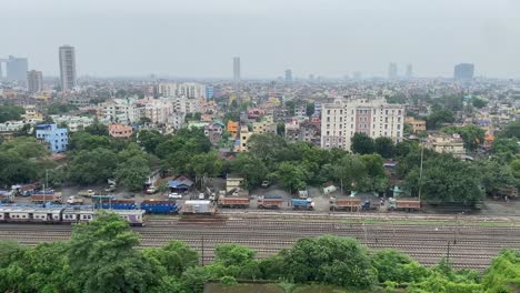 aerial view of a moving train and multiple tracks with a beautiful city view