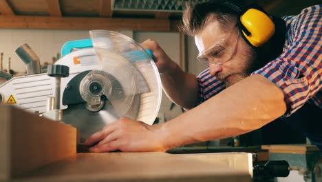 professional carpenter uses circular saw while working with wood.