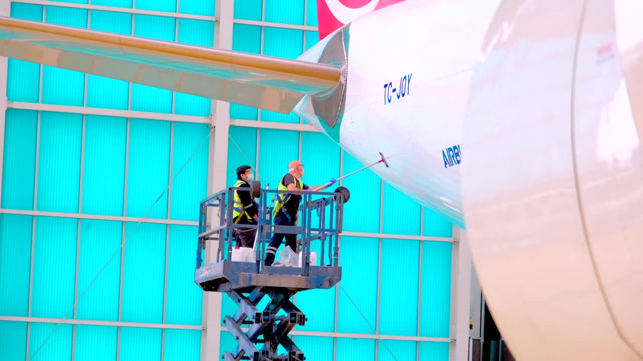 Workers cleaning aircraft washing disinfecting