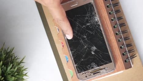 broken smartphone on a notebook