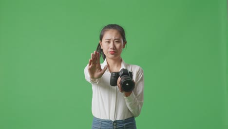 woman holding camera and rejecting