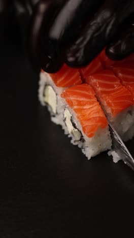 cutting salmon sushi rolls