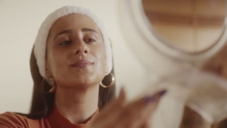 woman reflecting and smiling during skincare routine