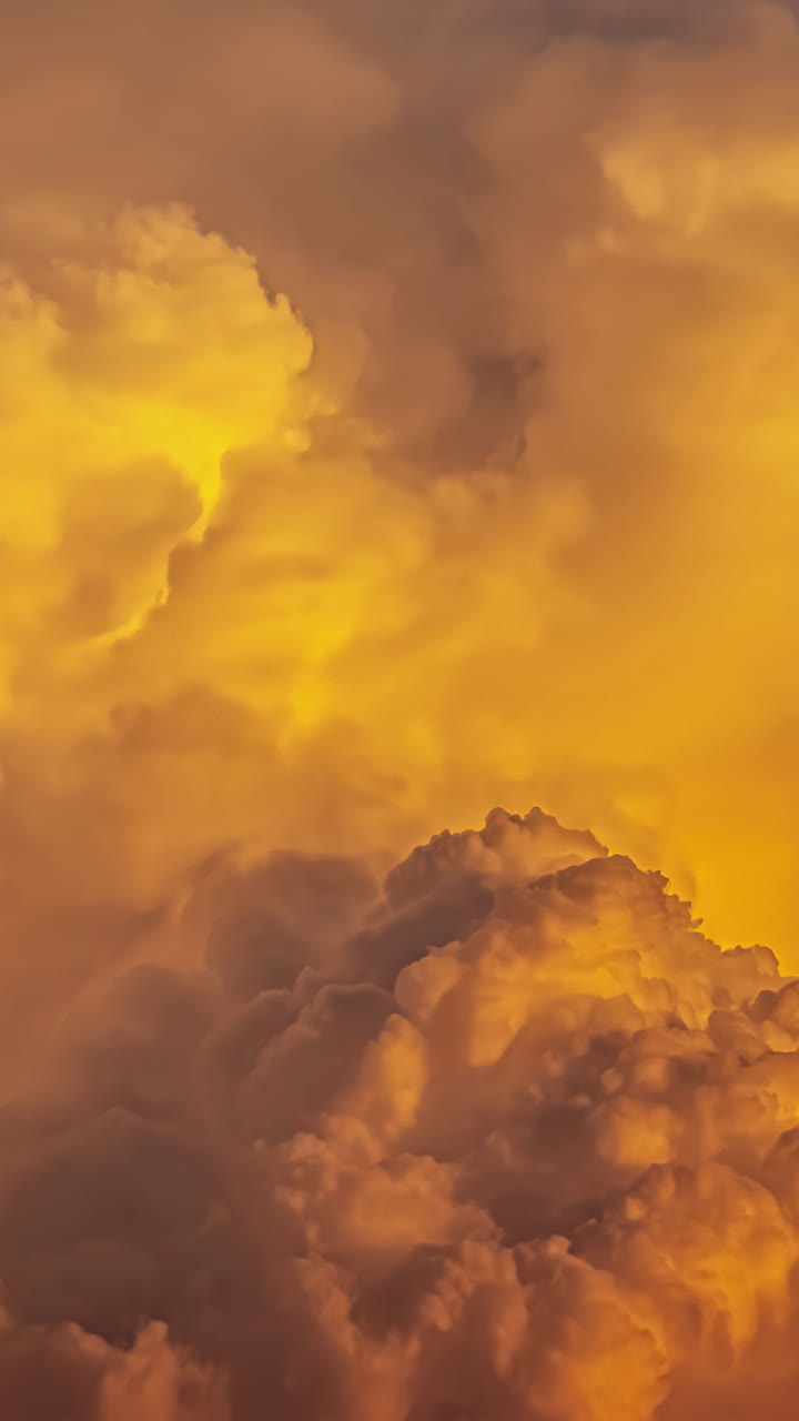 Vivid, golden clouds in a vertical timelapse, evoking wonder and awe