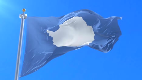 la bandera de la antártida ondeando lentamente con el cielo azul, bucle