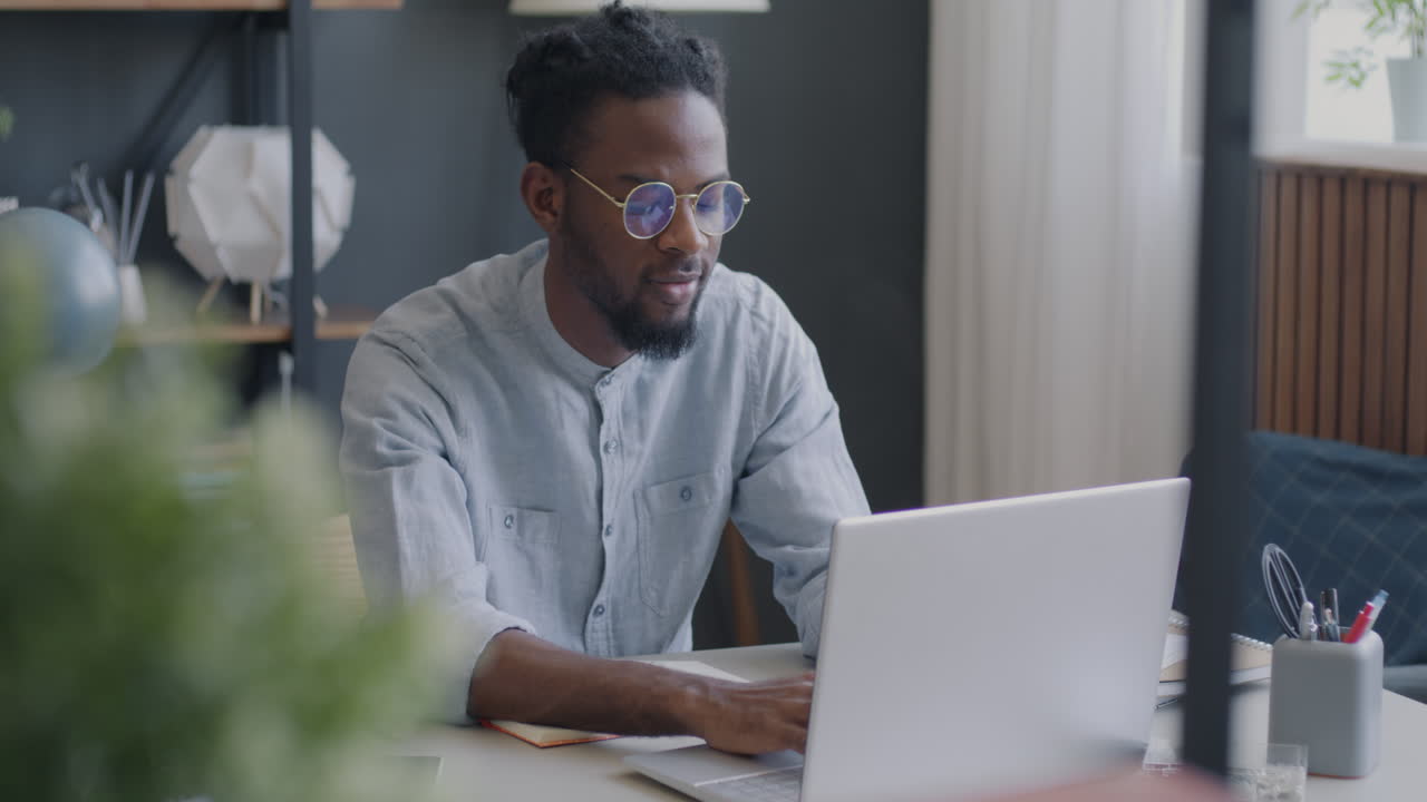 Man Working on Laptop in a Modern Office