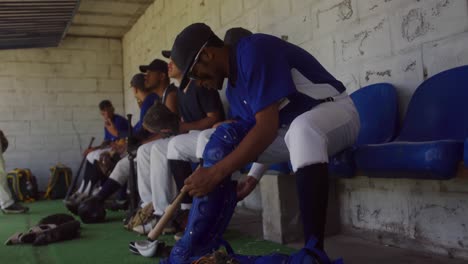 baseball player putting on his equipment