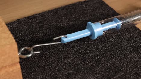 a spring scale pulls a wooden block across a carpet, illustrating friction force measurement in a controlled environment