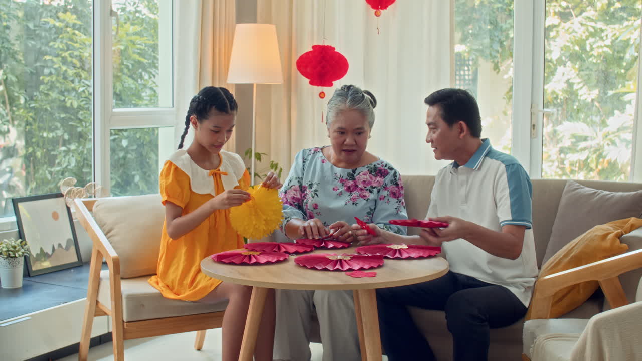Girl Gluing Decorations for Tet Holiday with Family