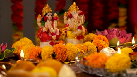 diwlai puja - flower showering to indian god ganesha and lakshmi idol / murti