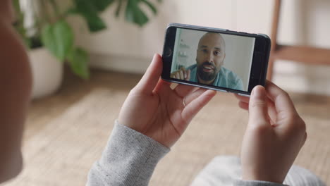 young woman having video chat using smartphone at home chatting to boyfriend enjoying conversation sharing lifestyle communicating with mobile phone