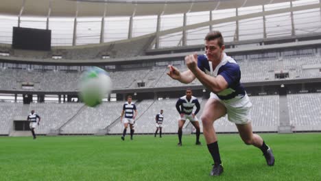 Male-rugby-players-playing-rugby-match-in-stadium-4k