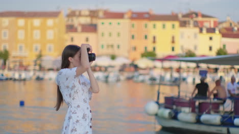 woman taking pictures in a coastal town