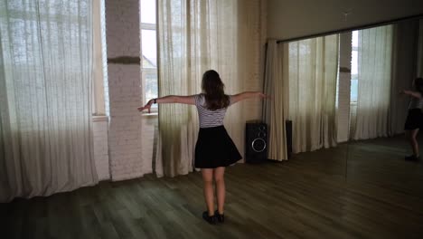 teenage girl having fun dancing alone in the studio slow motion