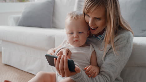 Mutter-Und-Baby-Video-Chat-Mit-Dem-Smartphone.-Glückliche-Mutter-Hält-Kleinkind-In-Der-Hand,-Teilt-Den-Mutterschaftslebensstil-Mit-Einer-Freundin-In-Den-Sozialen-Medien-Und-Genießt-Mobile-Technologie-In-4K