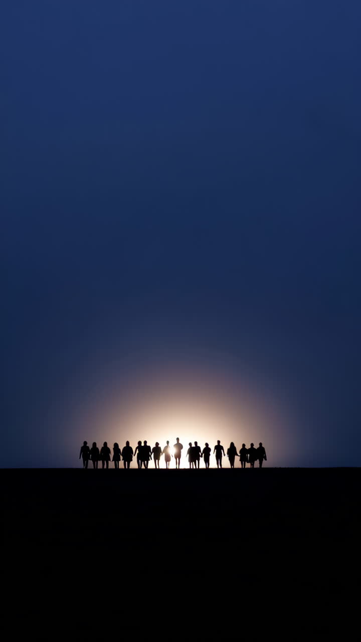 Silhouettes of a Group of People Against a Sunset