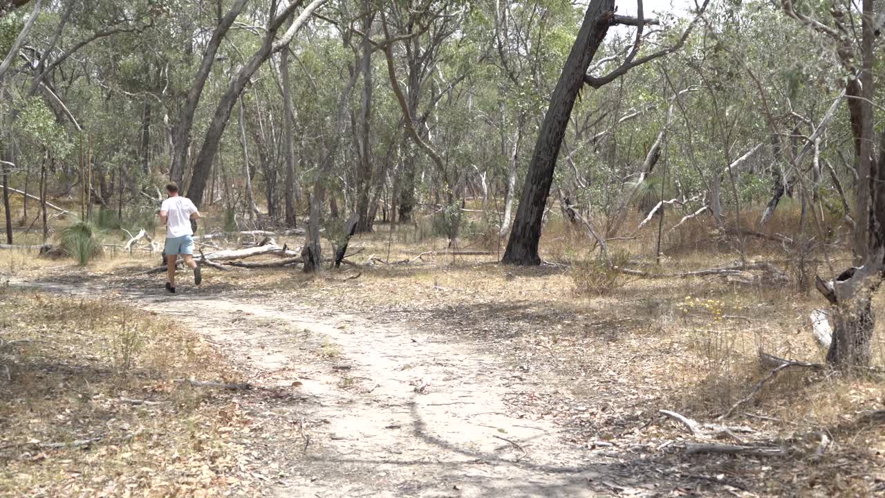 todavía disparó al hombre trotando a través de la escena en el monte