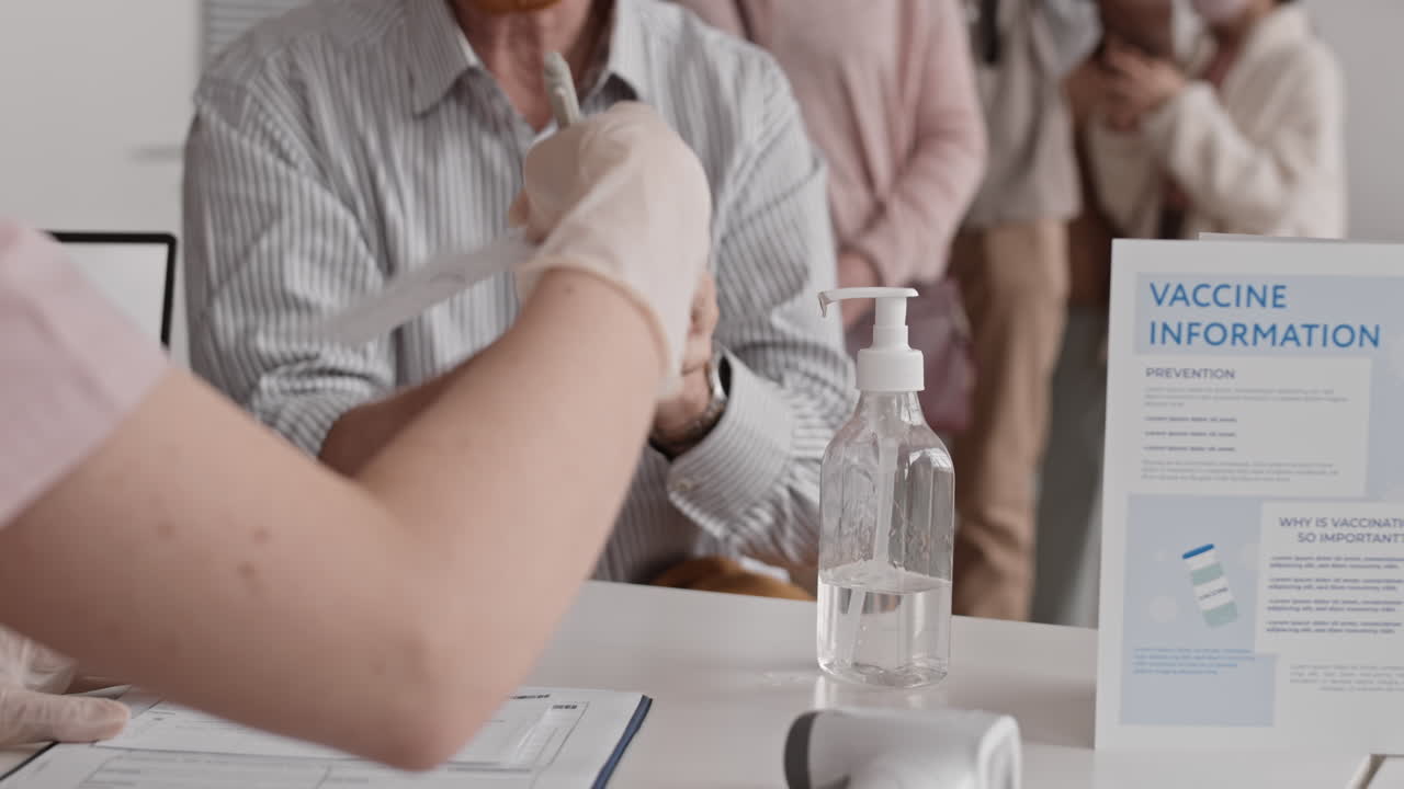 Unrecognizable People Pumping Sanitizer on Hands