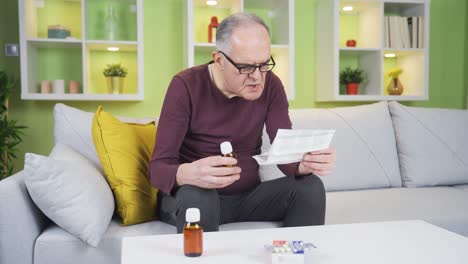 The-old-man-mixing-the-pills-looks-at-the-prescription.