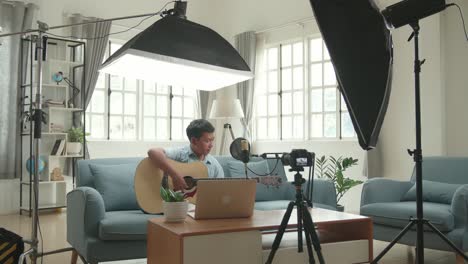teenage musician recording a song at home