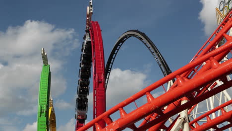 a roller coaster goes around a looping track at an amusement park