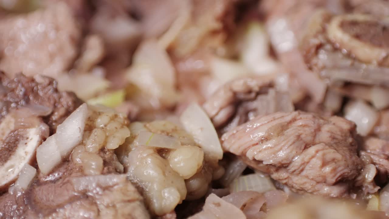 Chicken or pork stew with red and green pepper onion, and spices cooking in a frying pan. Traditional mexican cuisine, tacos preparation, ragout.