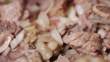 chicken or pork stew with red and green pepper onion, and spices cooking in a frying pan. traditional mexican cuisine, tacos preparation, ragout.