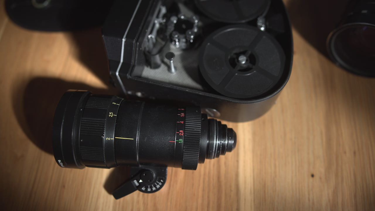 Closeup Lens Next To Open Film Mechanism On Wooden Table, Reel Details And Optical Components Visible, Vintage . Media