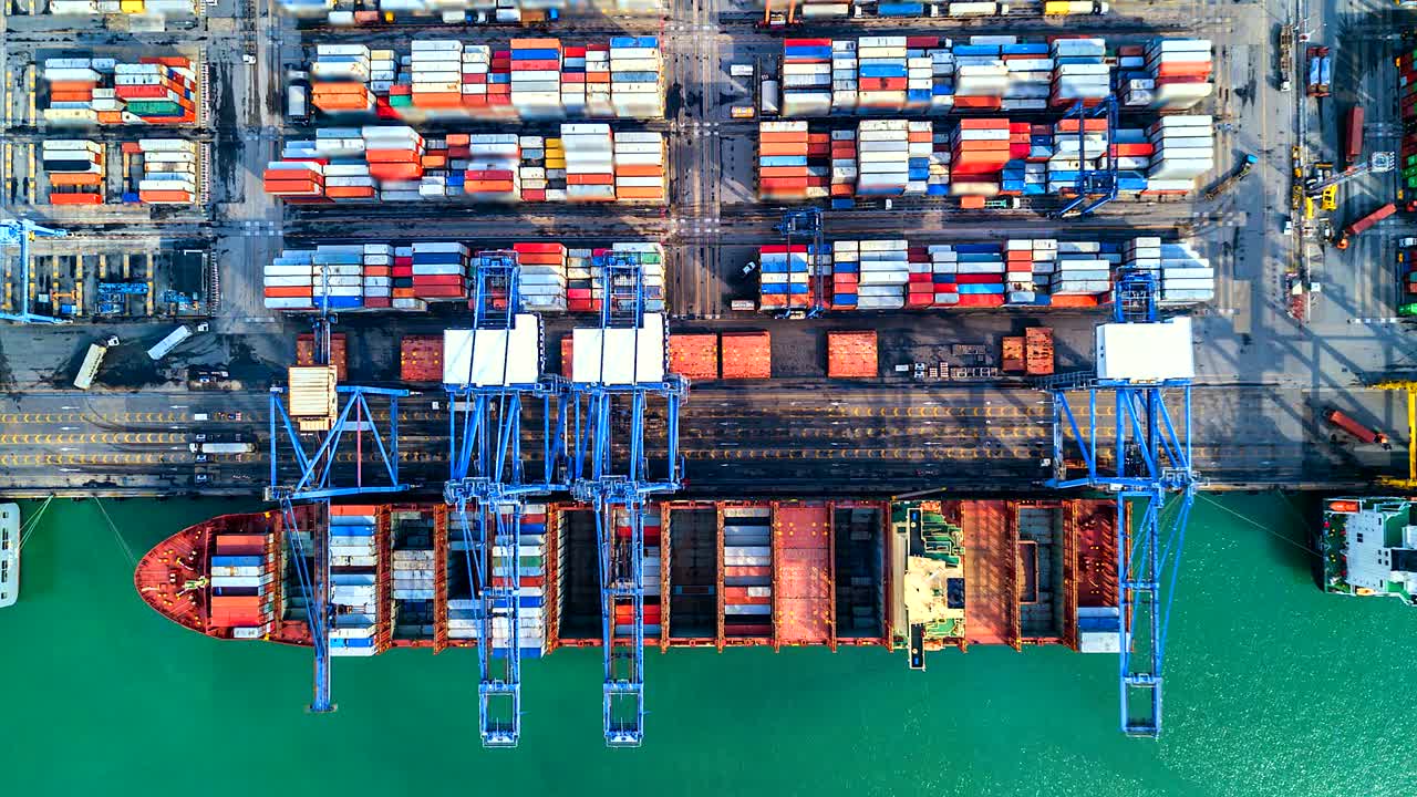 Aerial view, 4K.Time lapse Industrial port with Container port where is a part of shipping