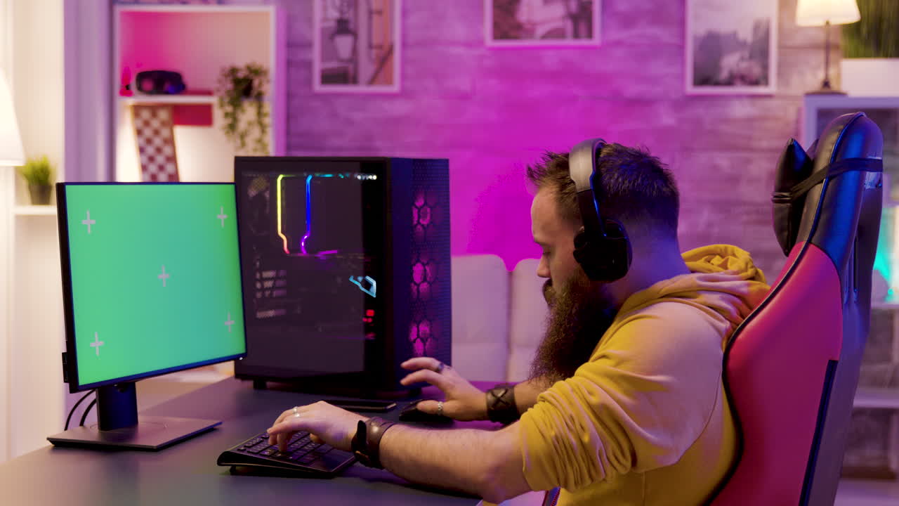 Gamer playing computer games at home