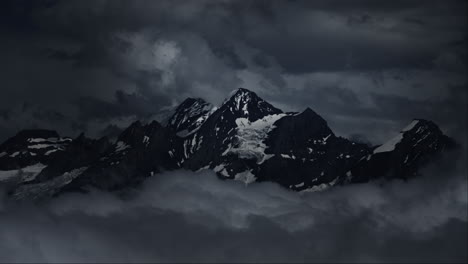 dark mountain peaks pierced by storm clouds