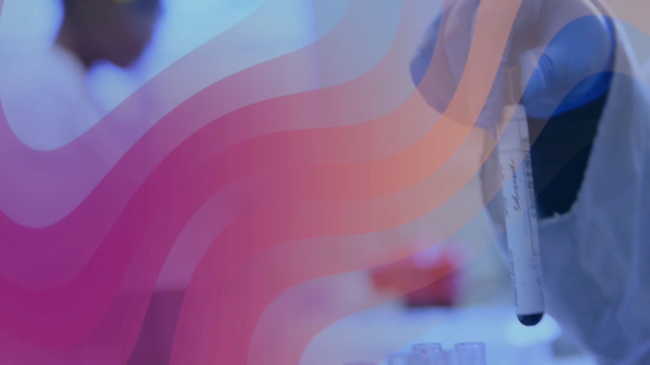 Lab technician's hand holding sample tube over lab bench, showing pink orange wave patterns