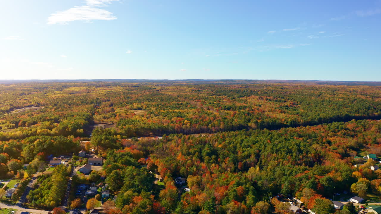 Aerial drone shot over the vast landscape of Nova Scotia, Canada. High view of the vast forest. Autumn colorful foliage. Picturesque scenic landscape.