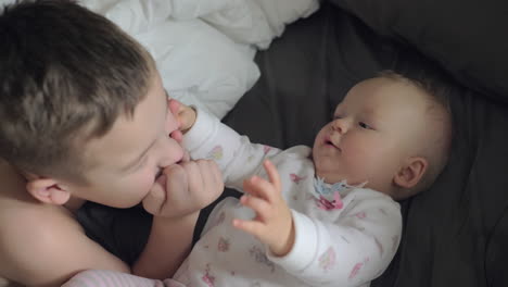 Happy-young-boy-with-his-baby-sister-caucasian