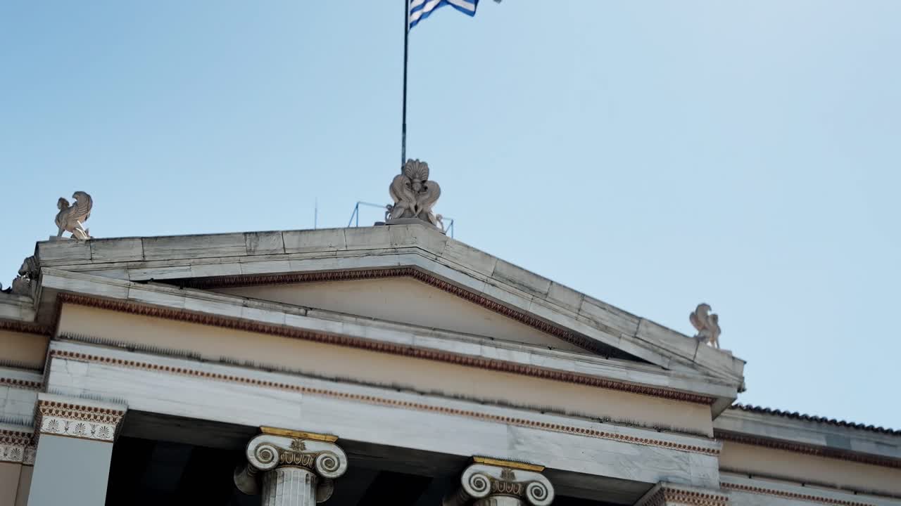 Greek Flag Waving Proudly Above Athens University Building