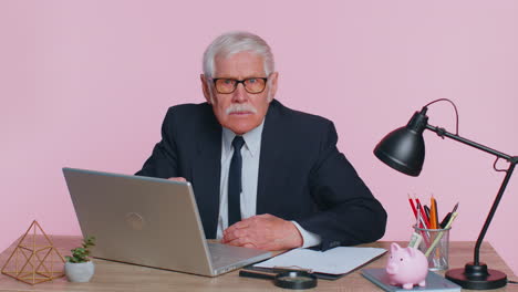 aggressive angry senior business man trying to fight at camera, shaking fist, boxing, punishment