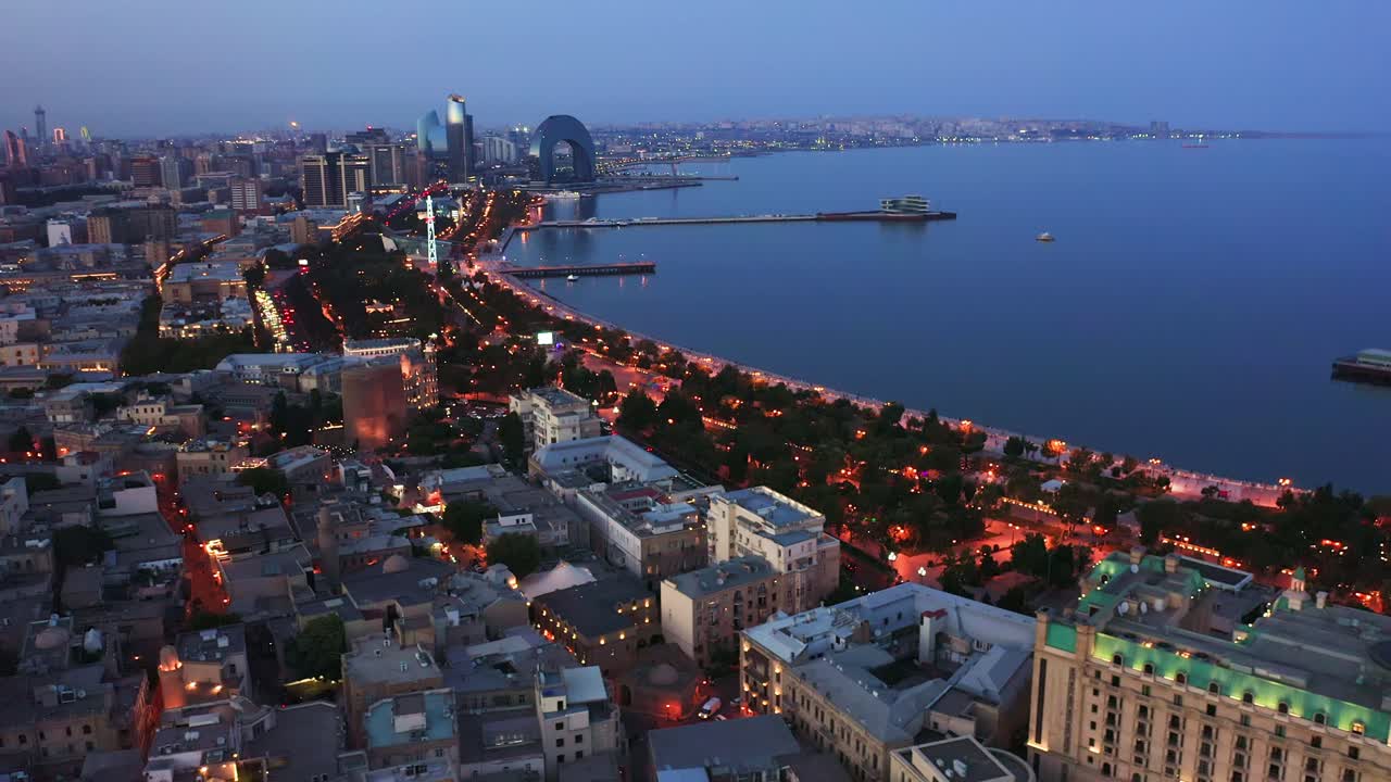 Flying above Baku city downtown district and old town İ&ccedil;ərişəhər at night